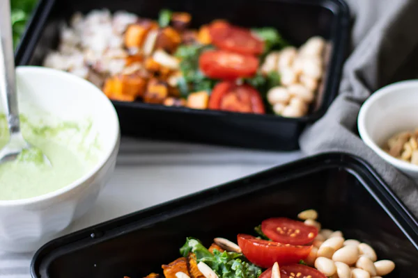 Prepared trays of colorful high-protein meals.